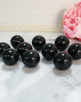Black Obsidian Natural Crystal Sphere Gemstone Orb Marble - One 30mm Sphere - Group of Crystal Orbs on Tile