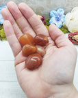 red aventurine crystals in hand