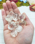 Clear obsidian stones in hand
