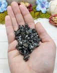 hand holding shungite stone pieces