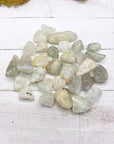 tumbled aquamarine stone pieces on display