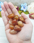 red aventurine crystals in hand