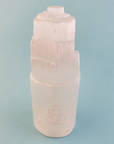 White Selenite Crystal Tower - Engraved with Triquetra - On Blue Background