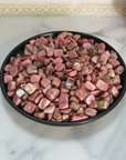 Rhodonite Crystal Pebbles Natural Gemstone Chips By the Ounce - Pink Rhodonite Crystal Chips in Black Ceramic Dish