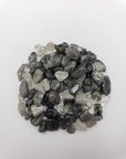 1 ounce of black tourmaline rutilated quartz on white background