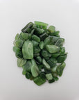 One ounce of nephrite jade chips on white background