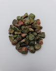 1 ounce of unakite stone chips on white background