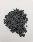 rough shungite stone chips on white background