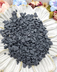 rough shungite stone chips on floral dish display