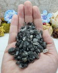 three ounces of black tourmaline rutilated quartz in hand