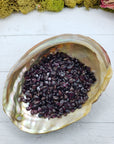 three ounces of garnet crystal chips in abalone shell