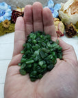 Hand holding three ounces of nephrite jade chips
