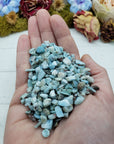 Three ounces of larimar crystal chips in hand