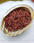 three ounces of red jasper stone chips in abalone shell
