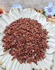 Seven ounces of red jasper stone chips on floral dish display
