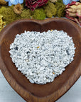 Eight ounces of howlite crystal chips in wooden bowl