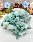 Large, small, and medium rough amazonite stones in pile