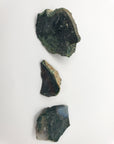 Three rough bloodstone crystal stones on white background for top-down biew