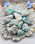 Floral dish with several rough blue aragonite stones