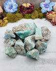 Collection of rough blue aragonite on display
