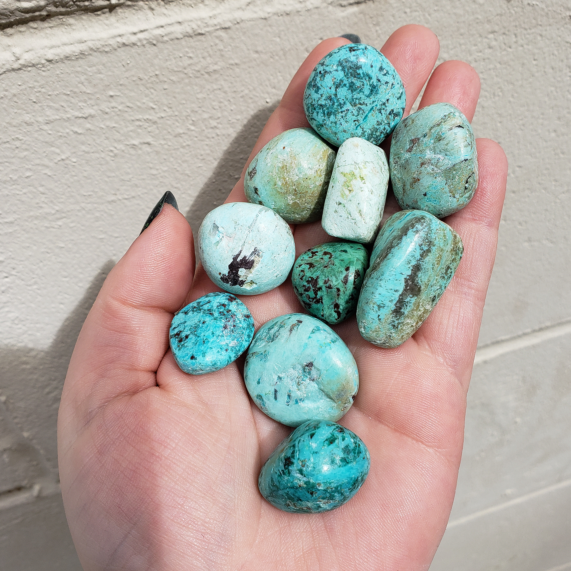 Peruvian Turquoise Natural Tumbled Stone - One Stone - Brick Background, Stones in Hand