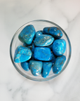 Turquenite Blue Howlite Dyed Tumbled Stone - One Stone - In Glass Bowl from Above