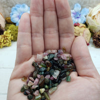 One ounce of mixed multi tourmaline chips in hand