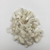 One ounce of rainbow moonstone chips on white background