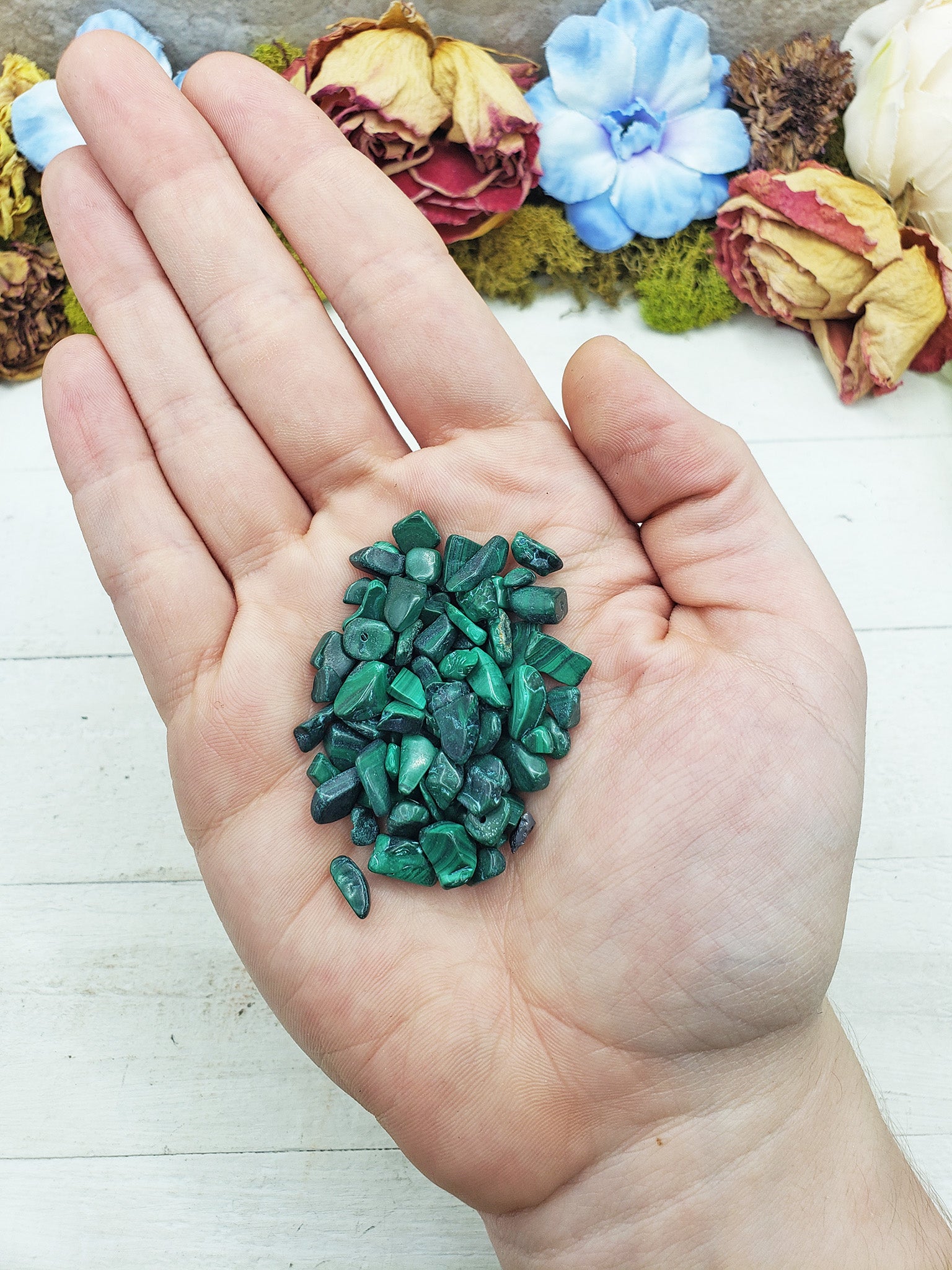 malachite crystal chips in hand