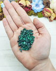 malachite crystal chips in hand