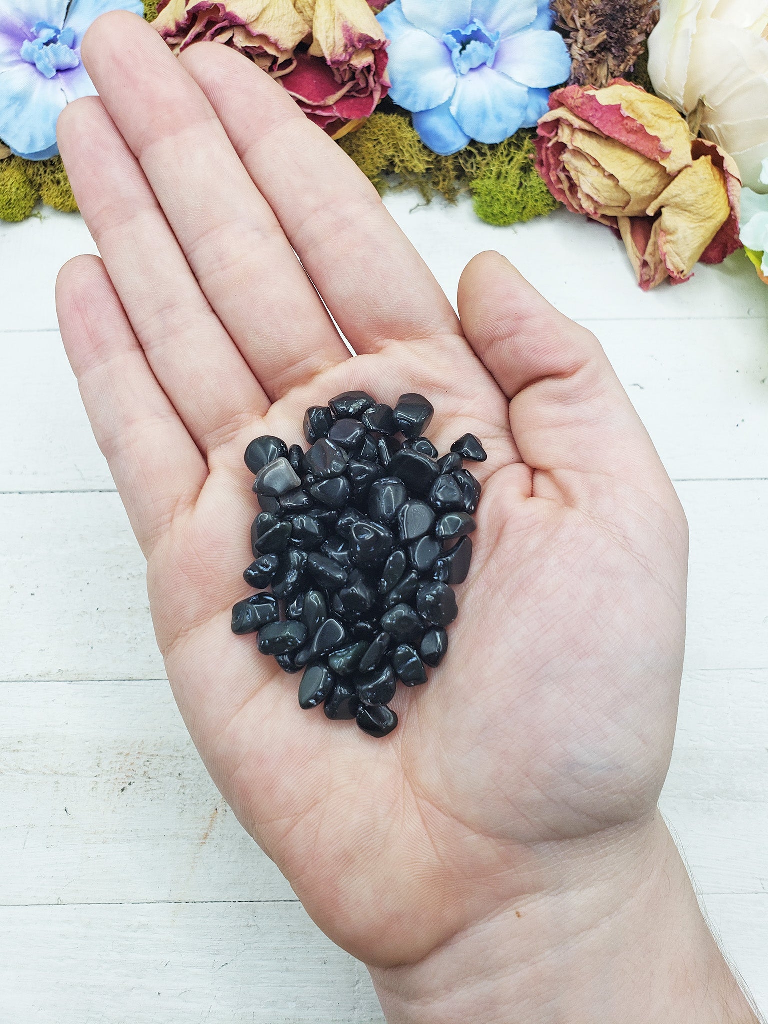 rainbow obsidian crystal chips in hand