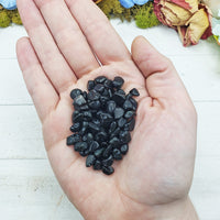 rainbow obsidian crystal chips in hand
