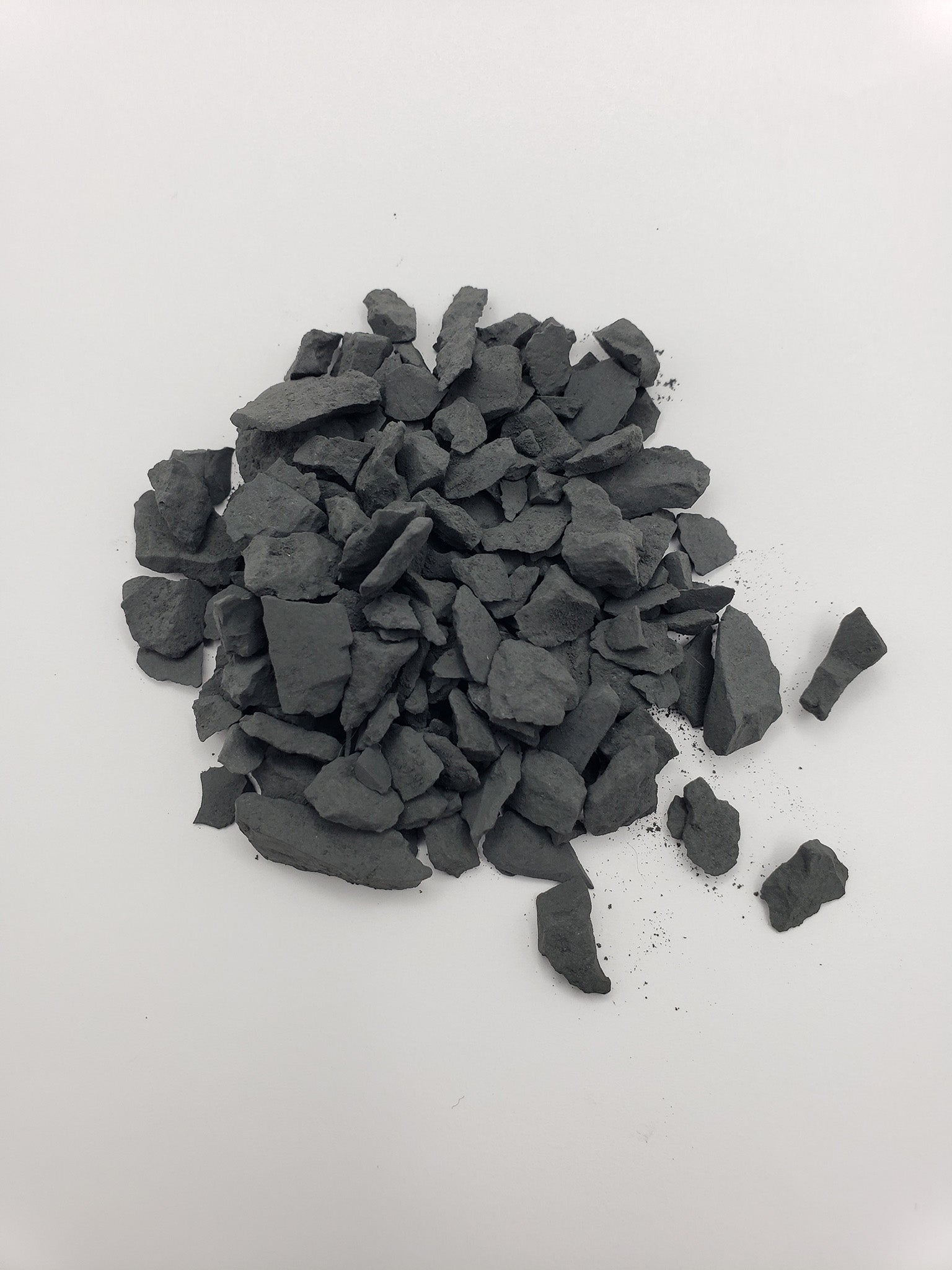 rough shungite stone chips on white background