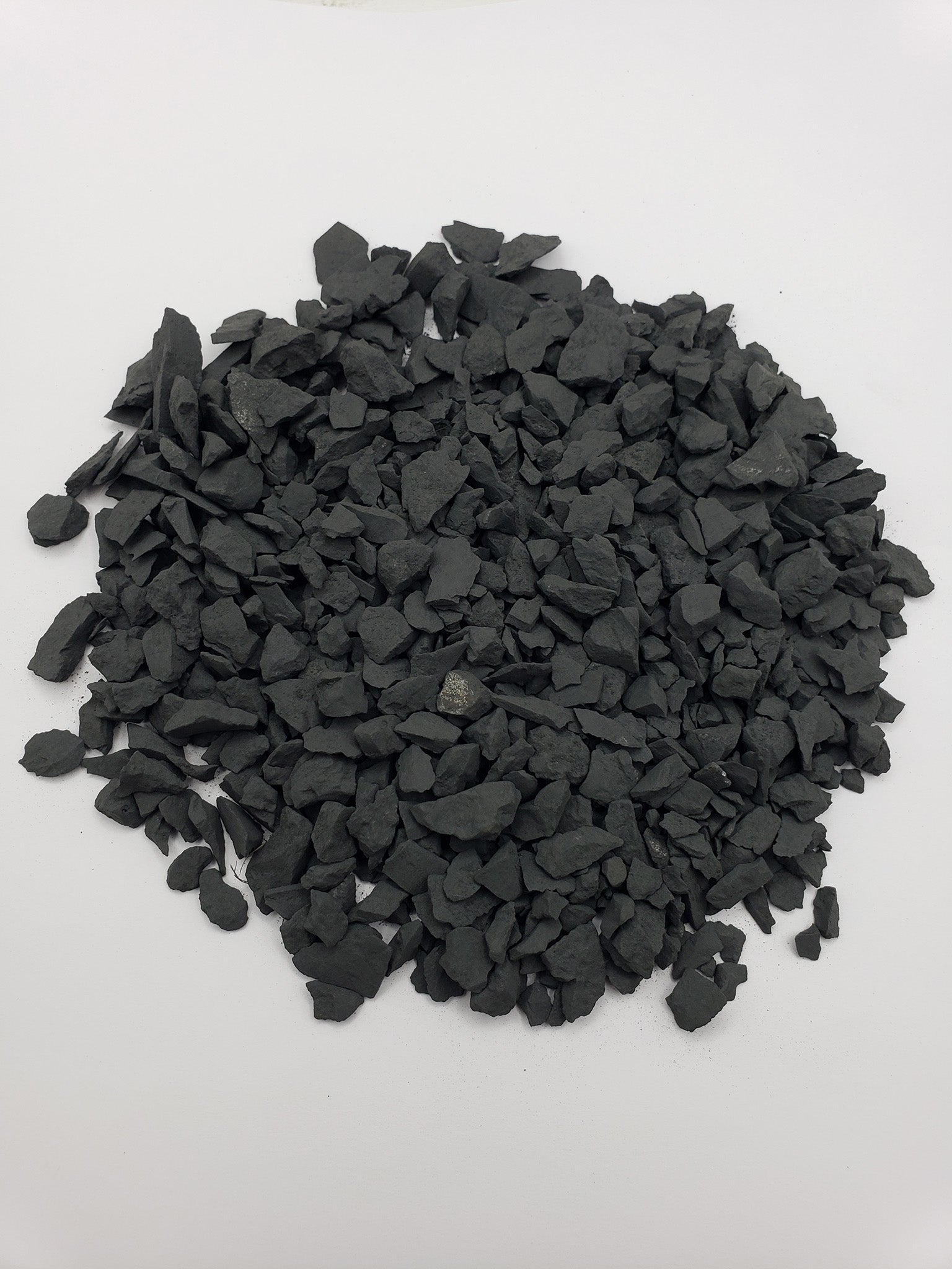 rough shungite stone chips on white background