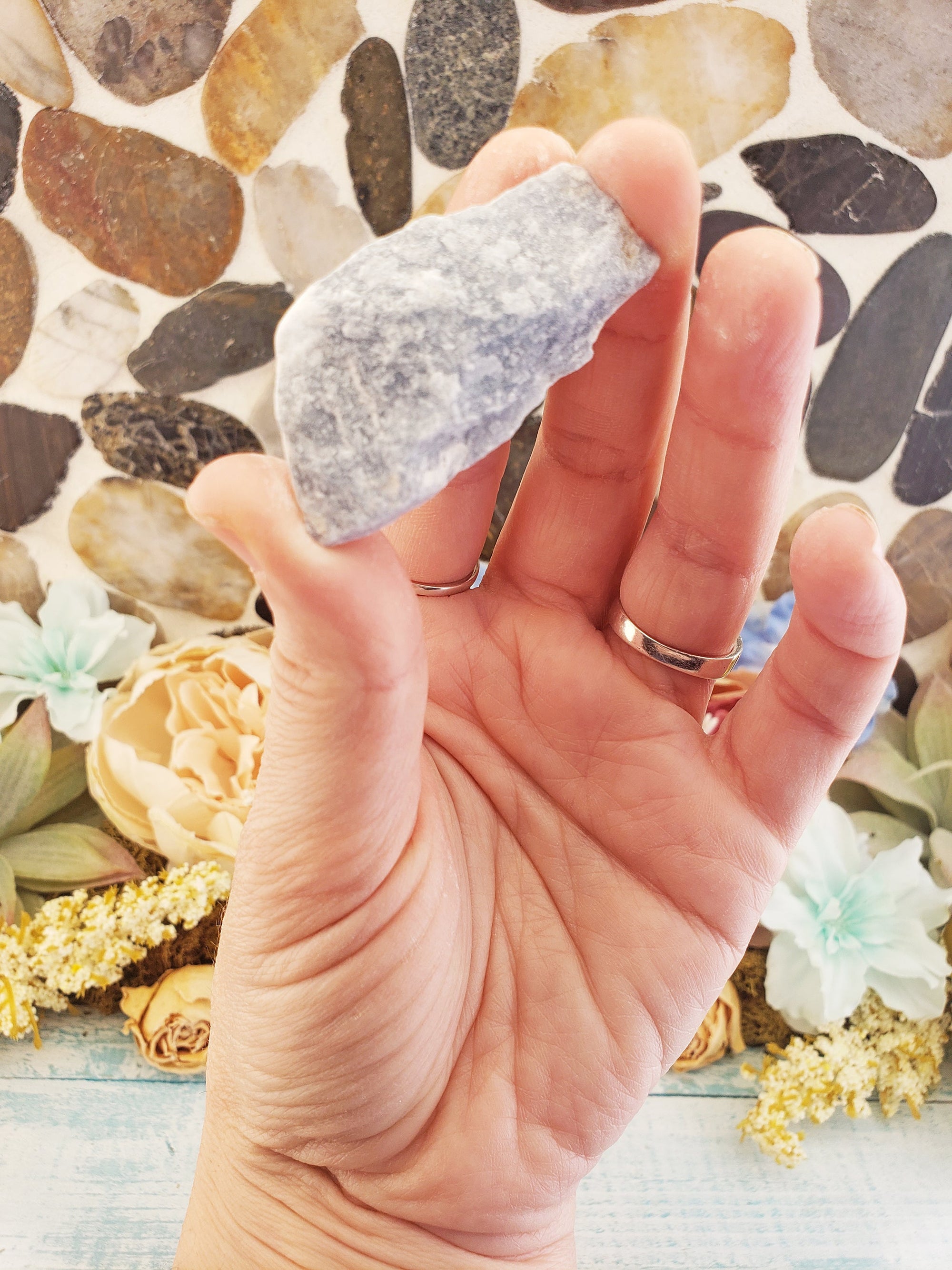 rough angelite stone between fingers