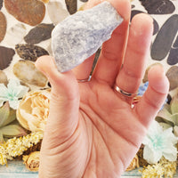 rough angelite stone between fingers