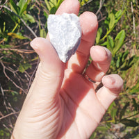 rough angelite stones in hand