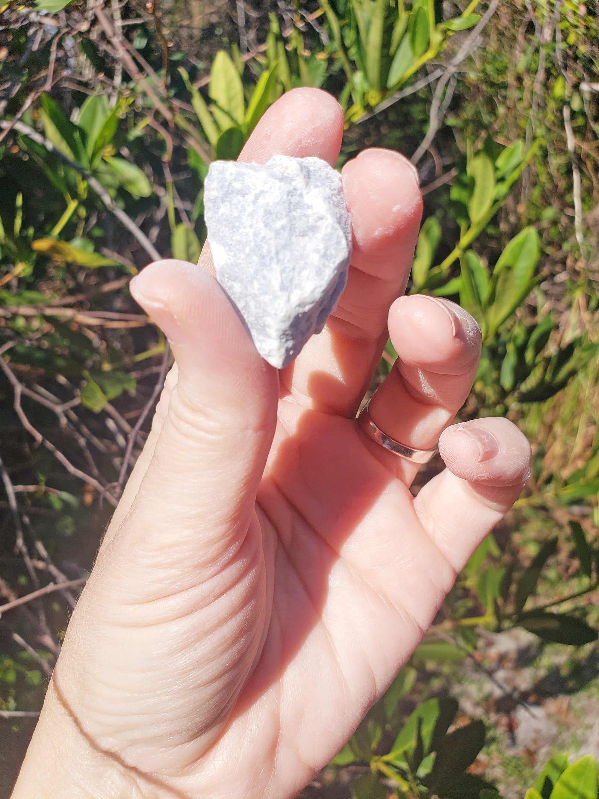 rough angelite stones in hand