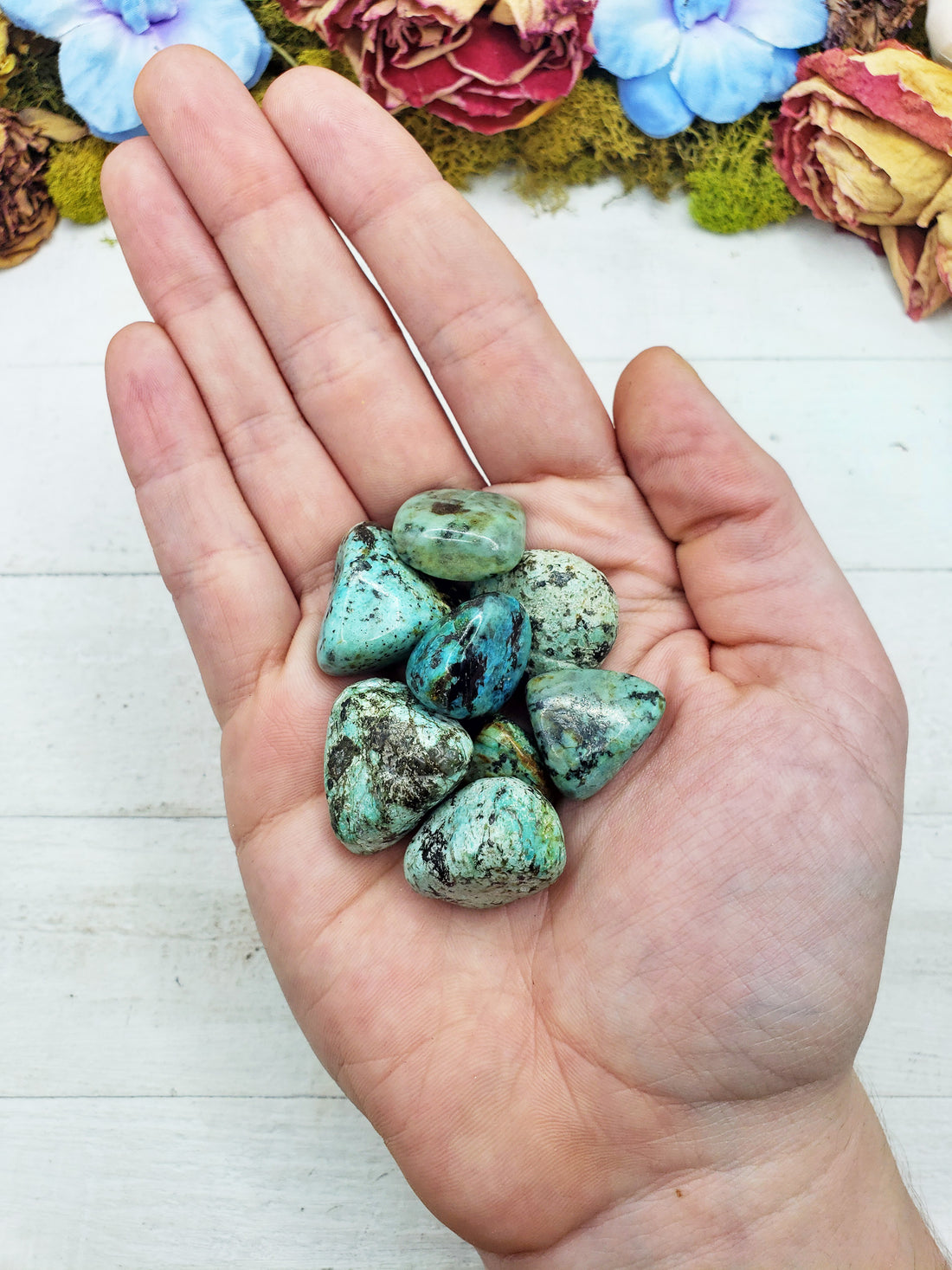 african turquoise stones in hand
