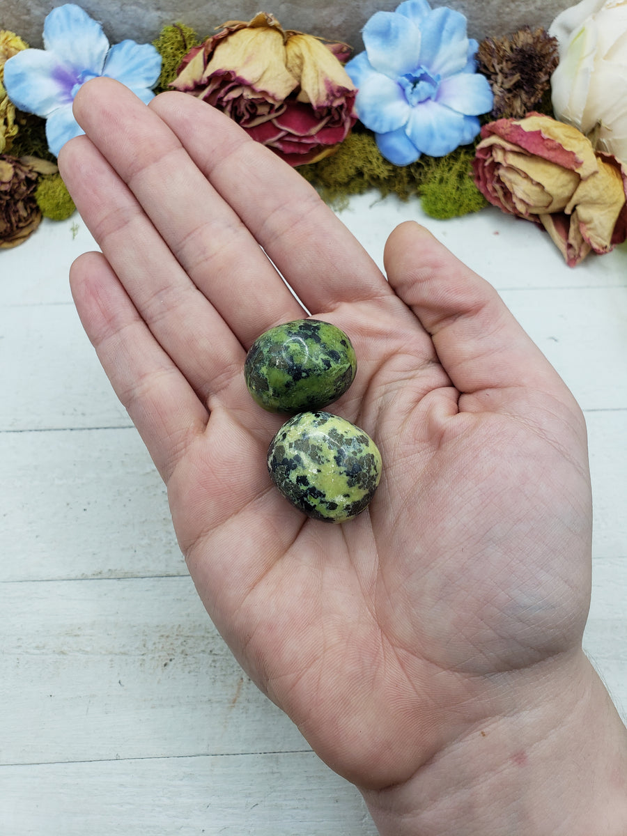 green serpentine stones in hand