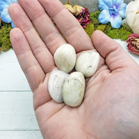 kunzite stone pieces in hand