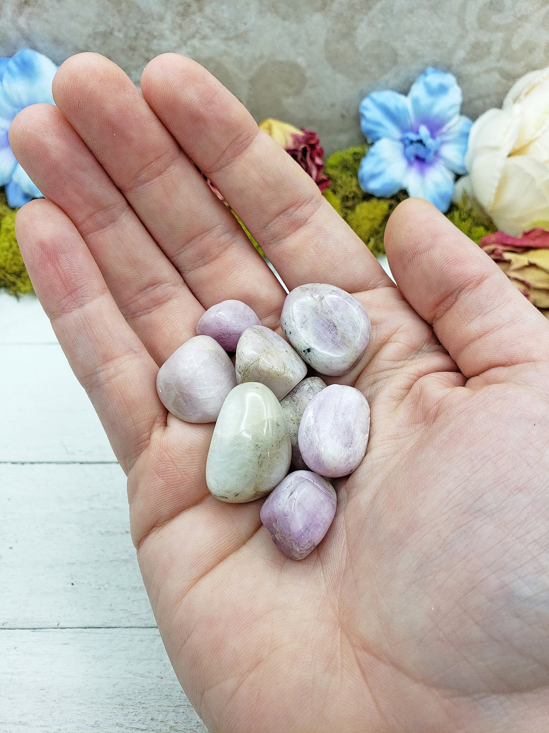 tumbled kunzite stone pieces in hand