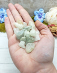tumbled aquamarine stone pieces in hand