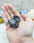 apache tear stones in hand
