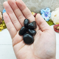 black agate stones in hand