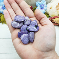 Charoite stones in hand