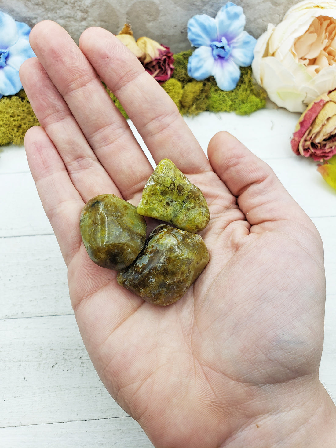 green opal stones in hand
