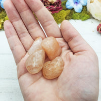 light strawberry quartz stones in hand