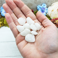 milky quartz stones in hand