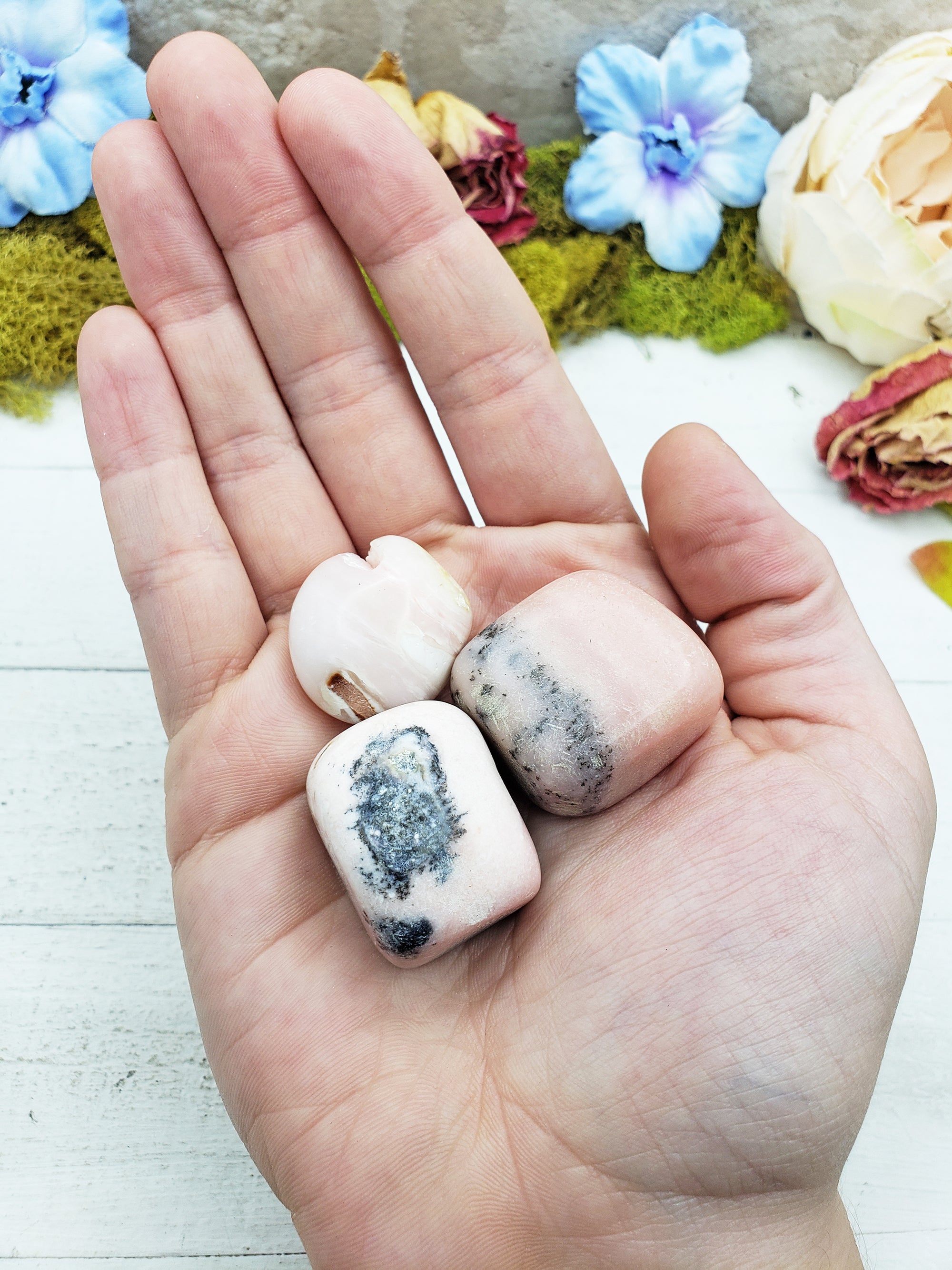 Pink Opal stones in hand